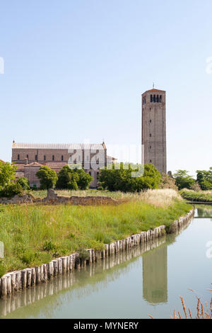 Basilica di Santa Maria Assunta bei Sonnenaufgang, Torcello, Insel, Venedig, Venetien, Italien mit der Glockenturm Campanile oder in den Kanal wider. Stockfoto