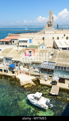 Cabanons in Endoume in Marseille, Frankreich, mit einem Boot in das klare Wasser und die Porte d'Orient, das Denkmal für die Östlichen Armee günstig Stockfoto