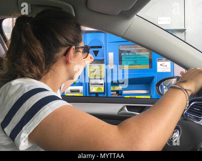 Sterzing, Italien - 1. Juni 2017: Frau im Auto in bar zahlen an einer italienischen Mautstelle für die Nutzung der Autobahn (Autostrada) Stockfoto