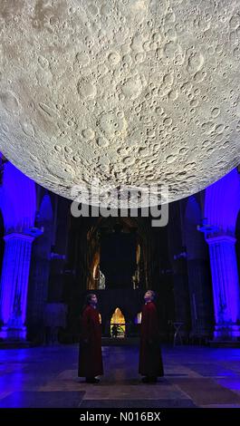 Exeter, Devon, Großbritannien. 2nd. Februar 2022. Drücken Sie Vorschau. Das Museum des Mondes landet in der Kathedrale von Exeter. Choristen blicken auf die Mondskulptur. Der Künstler Luke Jerram präsentiert seine nachgebildete Mondskulptur vom 3rd. Bis 27th. Februar in der weltberühmten Exeter Cathedral in Devon, Großbritannien. 2nd. Februar 2022. Credit Luke Jerram/Exeter Cathedral/nidpor/Alamy Live News Stockfoto