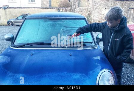 UK Wetter: Jack Porter kratzt Eis von einer Autoscheibe vor der Schule in frostigen Doddiscombsleigh, Devon, Großbritannien. 11th. Februar 2022. Credit nidpor/Alamy Live News Credit: Nidpor/StockimoNews/Alamy Live News Stockfoto