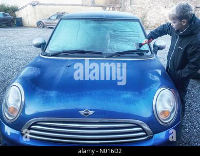 UK Wetter: Jack Porter kratzt Eis einer gefrorenen Autoscheibe vor der Schule in frostigen Doddiscombsleigh, Devon, Großbritannien. 11th. Februar 2022. Credit nidpor/Alamy Live News Credit: Nidpor/StockimoNews/Alamy Live News Stockfoto