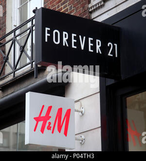 Ein Zweig der Ewig 21 Neben einem H&M Store auf der Oxford Street in Central London. Stockfoto