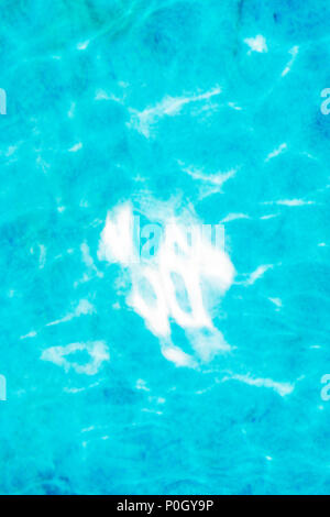 Reflektierte Sonnenlicht schafft abstrakte Muster im Außenpool Stockfoto