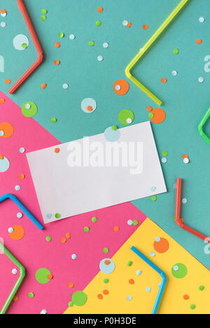 Lebendige Konfetti und Strohhalme auf Pastell Pink, Blau, Gelb mit sauberen, weißen leer für Ihren Text. Festliche Kulisse für ihr Design, Kopie Raum Stockfoto