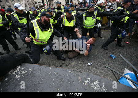 Polizei mit Schlagstöcken zurück halten Verfechter von Tommy Robinson während ihren Protest in Trafalgar Square, London Calling für seine Entlassung aus dem Gefängnis. Stockfoto