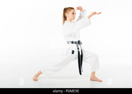 Mädchen im Kimono training Karate isoliert auf weißem Stockfoto