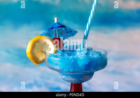 Bunte blau Cocktail mit Zitrone und Kirsche garnieren und Blau trinken Regenschirm Stockfoto