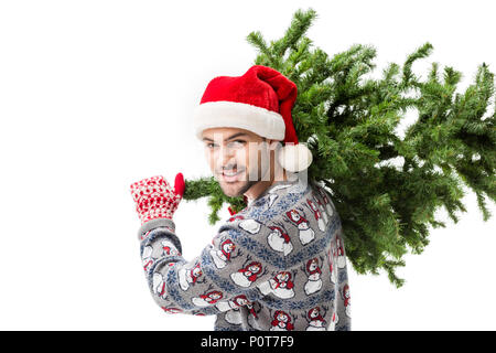 Junger Mann in santa hut mit Weihnachten Tannenbaum isoliert auf weißem Stockfoto