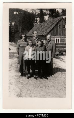 Der TSCHECHOSLOWAKISCHEN SOZIALISTISCHEN REPUBLIK, ca. 1950: vintage Foto zeigt eine Gruppe von Menschen vor einem Blockhaus im Winter, ca. 1950er-Jahre. Stockfoto