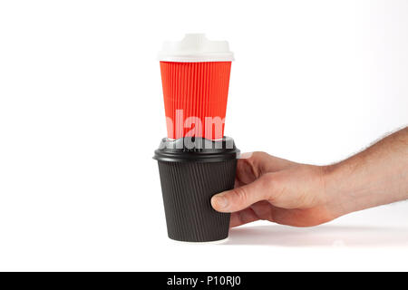 Männliche Hand schwarz Einweg Kaffeebecher mit roten Kaffeetasse auf es - auf weißem Hintergrund mit Kopie Raum Stockfoto