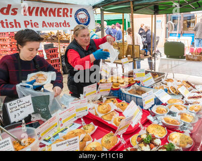 Lady Standbesitzer mit Anzeige von ihr populäres Kosak Küchen prämierten russischen Stil Torten und Kuchen für den Verkauf in Saltburn Bauernmarkt im Sommer Stockfoto