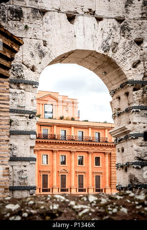 Blick auf moderne römische Gebäude durch Arch in der antiken Kolosseum oder Colosseo, kontrastierenden alten und neuen, Perspektive, aus dem Inneren des Kolosseums genommen Stockfoto