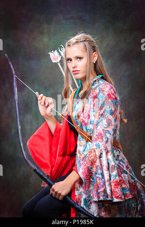 Studio Portrait des Weiblichen elf mit einem Bogen Stockfoto