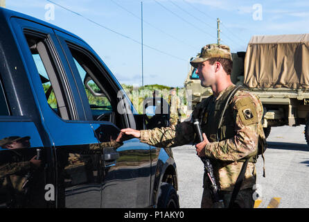 Flagler County, FL - ein Soldat von Alpha Company zweiten Bataillon 124 Infanterie Regiment gab Bewohner wichtige Informationen, um Ihnen zu helfen, sicher erneut ein der Sturm Bereich erfolgt auf Flagler County Küste Oktober 8th, 2016. Us-Armee Foto von Cadet Abigail Fellows. Stockfoto