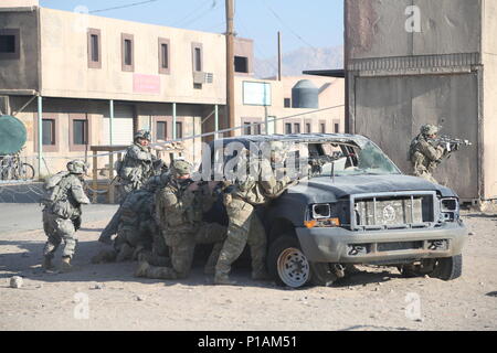 Us-Soldaten in den 2 Bataillon zugeordnet, 7 Golgatha Regiment, suchen Sie nach einem aufständischen Feuern aus einer erhöhten Position kämpfen, während der entscheidende Maßnahmen Rotation 17-01 an der National Training Center, Fort Irwin, Calif., Okt. 4, 2016. Entscheidende Maßnahmen Rotationen erzeugen eine realistische Umgebung, die die Funktionalität von Brigade Combat Teams vorbereiten, ähnlich ausgestatteten Gegenkräfte Tests. (U.S. Armee Foto von Sgt. Ernesto Gonzalez, Operations, National Training Center) Stockfoto