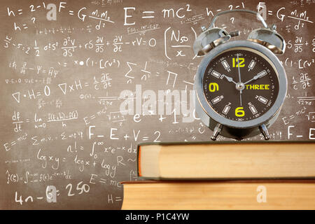 Das zusammengesetzte Bild im Wecker auf Stapel Bücher gesetzt Stockfoto