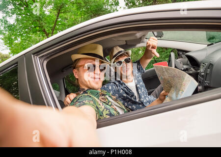 Freunde im Auto für die Straße Urlaub Reise und unter Self Portrait über Handy. Stockfoto