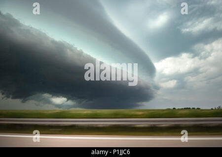 Leistungsstarke Shelf cloud mit einem entgegenkommenden mesoskaligen konvektiven System (MCS) von einem fahrenden Auto in der Nähe von Döbeln, Sachsen, Deutschland Stockfoto