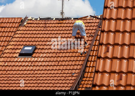 Mann auf dem Dach eines Gebäudes arbeiten Stockfoto