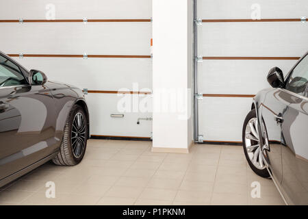 Home Garage für 2 Fahrzeuge. Sauber Luxus Autos zu Hause geparkt. Automatische Fernbedienung der Türen. Transport überdachte Lagerung. Stockfoto