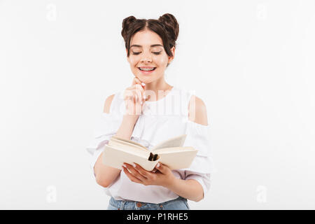 Foto von Studium Studentin oder Schülerin mit einem Brötchen Frisur und Zahnspangen lesen Buch mit Lächeln auf weißem Hintergrund Stockfoto