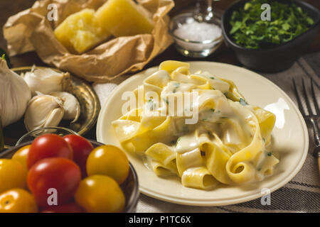 Alfredo Pasta Teller mit cremiger Käse und Basilikum Sauce Stockfoto