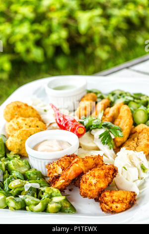 Panierte Frittierte Garnelen und Fisch serviert auf einem Tisch im Restaurant. Florianopolis, Santa Catarina, Brasilien. Stockfoto