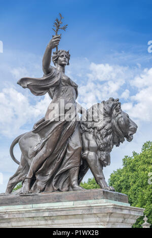 Einer der vier großen Bronzenen Löwen Skulpturen, Teil der Queen Victoria Memorial vor dem Buckingham Palace, zeigt eine Frau mit einer Olive Bran Stockfoto