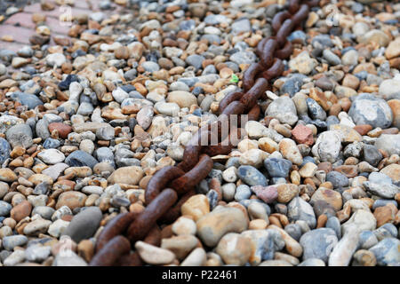 Alte rostige Kette auf Pebble Beach Stockfoto