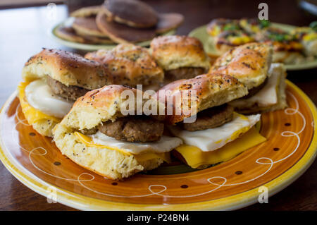 Wurst Ei und Käse Frühstück sanwich platter auf Zwiebel Mohn- Brötchen Stockfoto