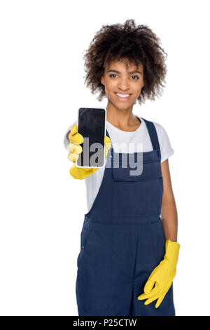 Portrait von lächelnden african american Cleaner zeigt Smartphone mit leerer Bildschirm isoliert auf weißem Stockfoto