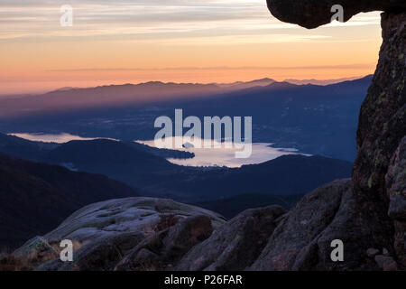 Aussicht auf den Lago d'Orta und die Isola di San Giulio aus einer Gruppe von Felsen an der Oberseite des Mottarone. Stresa, Verbano Cusio Ossola, Piemont, Italien. Stockfoto