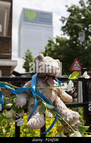 London, Großbritannien. 14 Jun, 2018. Bären Kinder und Kuscheltiere am Geländer in der Nähe, wo die Grenfell Feuer aufgetreten, am ersten Jahrestag des Hochhauses Katastrophe. 72 Menschen starben, als der Turm im Stadtteil Kensington & Chelsea, in welcher der größte Brand seit WW2 aufgerufen wurde getötet wurden. Das 24-stöckige Hochhaus Grenfell von Sozialwohnungen Wohnungen in Kensington, West London, Vereinigtes Königreich. Es verursachte 72 Todesfälle, in der 293 Personen im Gebäude, darunter 2, die Entronnenen und verstarb im Krankenhaus. Mehr als 70 wurden verletzt und traumatisiert. Credit: RichardBaker/Alamy leben Nachrichten Stockfoto