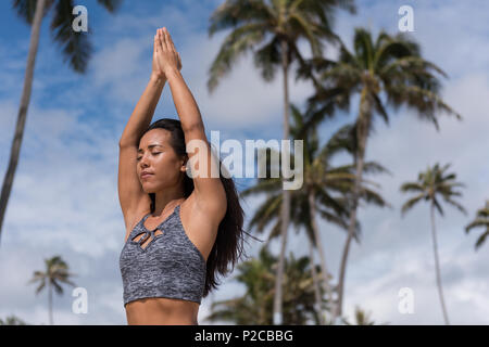 Frau durchführen Yoga am Strand Stockfoto