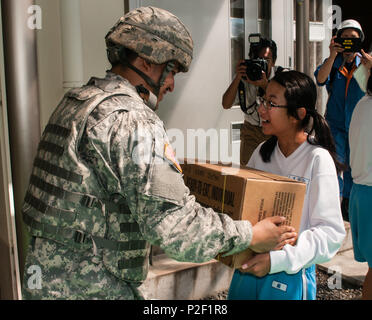 Armee SPC. Ruben A. Flores, ein Atlanta, Georgia, native als vorbeugende Medizin Spezialist für Öffentliche Gesundheit Command-Pacific, Hände eine Box von Mahlzeiten bereit zu essen Pakete an eine Studentin aus Osuka Junior High School in Kakegawa, Japan, Sept. 4, 2016. Flores und 11 andere US-Soldaten nahmen an der Präfektur Shizuoka der jährliche umfassende Disaster Bohren. Der Bohrer hat gezeigt, wie eine vielfältige Sammlung von lokalen, regionalen, nationalen und internationalen Organisationen Pool können ihre jeweiligen Ressourcen effektiv zu einer großen Katastrophe reagieren. Neben der Verteilung von Lieferungen, die Stockfoto