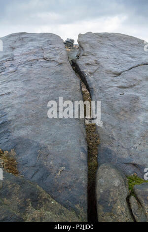 Ein Riss im gritstone Felsen in der Nähe von fairbrook Naze auf Kinder Scout in Derbyshire Peak District, England, Großbritannien Stockfoto