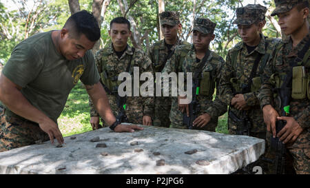 Sergeant Fitzgerald Cano, Links, Advisor, mit speziellen Zweck Marine Air-Ground Task Force - südliche Befehl spricht mit Marines mit dem Infanteria de Marina von El Salvador auf die Bedeutung auf Patrouillen und Gefechtsformationen in La Union, El Salvador, Sept. 29, 2016. In den nächsten Monaten Marinen werden neben ihren El Salvador Gegenparts partner Nation, die Interoperabilität zu verbessern und die regionale Sicherheit und Verteidigung Zusammenarbeit zu stärken. (U.S. Marine Corps Foto von Cpl. Kimberly Aguirre) Stockfoto