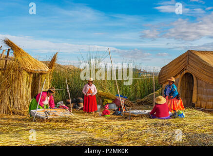 Eine Gruppe von Uros indigenen auf die schwimmenden Inseln aus Totora-Schilf Reed in der Titicaca See in der Nähe von Puno, Peru. Stockfoto