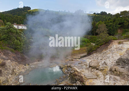 Hot Spring durch vulkanische Terrain und bergigen Landschaft in Furnas, Azoren, Portugal umgeben. Sommer Landschaft der Azoren Dorf an einem bewölkten Tag. Stockfoto