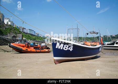 Tenby, Großbritannien: 11. Juni 2018: Boote im Hafen von Tenby bei Ebbe vertäut. Der Hafen ist in eine Ecke in Hafen Strand unterhalb Burg Hügel gebaut. Stockfoto