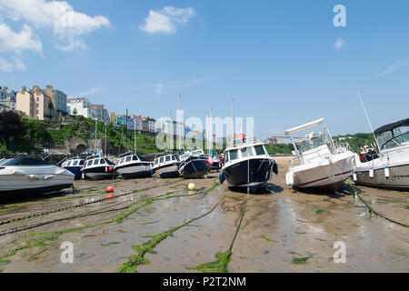 Tenby, Großbritannien: 11. Juni 2018: Boote im Hafen von Tenby bei Ebbe vertäut. Der Hafen ist in eine Ecke in Hafen Strand unterhalb Burg Hügel gebaut. Stockfoto