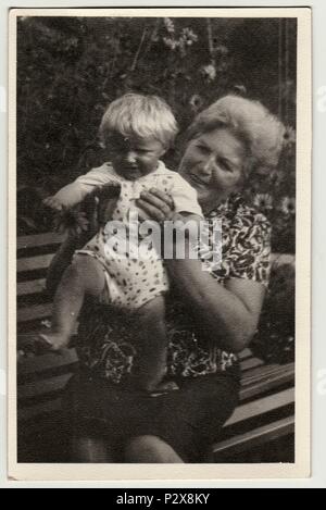 Die tschechoslowakische SOZIALISTISCHE REPUBLIK - circa 1950s: Vintage Foto zeigt Großmutter hält ein kleines Baby. Retro Schwarz/Weiß-Fotografie Stockfoto