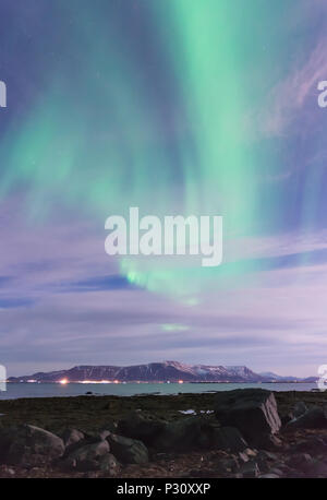 Swirl grün Aurora Borealis über einem schwarzen Sandstrand, das Meer und die Berge außerhalb von Reykjavik, Island Stockfoto