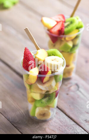 Obstsalat in Plastik Becher zum Mitnehmen. In Scheiben geschnitten Bio Früchte und Beeren, gesunden Snack zu gehen, Platz kopieren. Stockfoto