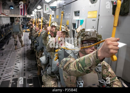 Mitglieder der US Army 1st Bataillon, 503Rd Infanterie Regiment, 173Rd Airborne Brigade für eine statische Zeile springen während der Übung Bajonett Streik Juni 13, 2018, über Julia Drop Zone, Italien vorbereiten. Der Sprung war mit Mitgliedern der Italienischen Armee 186th Airborne Regiment Forlgore Feuerwehr auf einer C-17 Globemaster III, durch 204. Airlift Squadron der Texas Air National Guard Betrieben statt. Die Ausbildung konzentriert sich auf die Verbesserung operativer Standards mit der NATO und anderen Air Mobility Command Flugzeuge sowie für die Entwicklung von einzelnen technischen Fähigkeiten. (U.S. Air National Guard Foto von älteren Flieger John Stockfoto