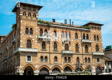 Ein altes, riesiges Gebäude im Zentrum der Stadt Treviso liegt an einem Platz. Es hat viele Bögen und Windows. Stockfoto