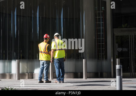 Zwei Bauarbeiter Konferenz vor Ort, NYC, USA Stockfoto