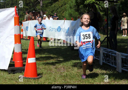 Jugend Teilnehmer rennen die Ziellinie während einer jährlichen Marine Corps Community Services' Sprint Triathlon Relais und Kids Triathlon bei Marine Corps Air Station Cherry Point, N.C. Diese Art der Unterstützung verdient MCCS Cherry Point 2017 nationale Goldmedaille Grand Plaque Award for Excellence. Die Auszeichnung, die im Jahr 2012 gegründet, die von der amerikanischen Akademie für Park- und Freizeit Verwaltung in Partnerschaft mit den nationalen Erholung und Park-Verbindung, erkennt die Beiträge von militärischen Freizeit Anbieter und die Arbeit, die Sie für die Mitglieder, ihre Familien und andere Gönner und lokalen Communi Stockfoto