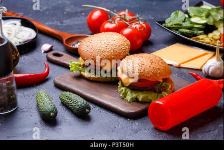 Foto von zwei Hamburger auf Holzbrett, Käse Stockfoto